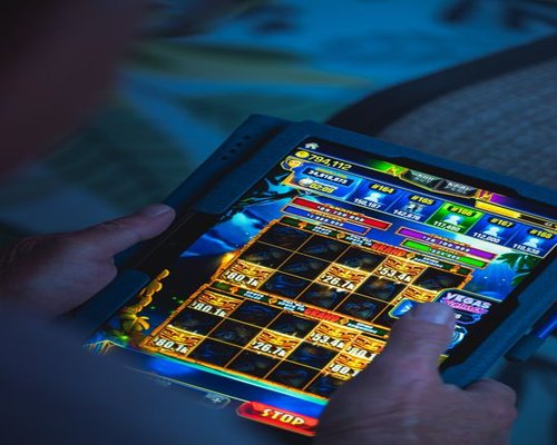 Mobile gaming interface shown inside an independent Australian technology display
